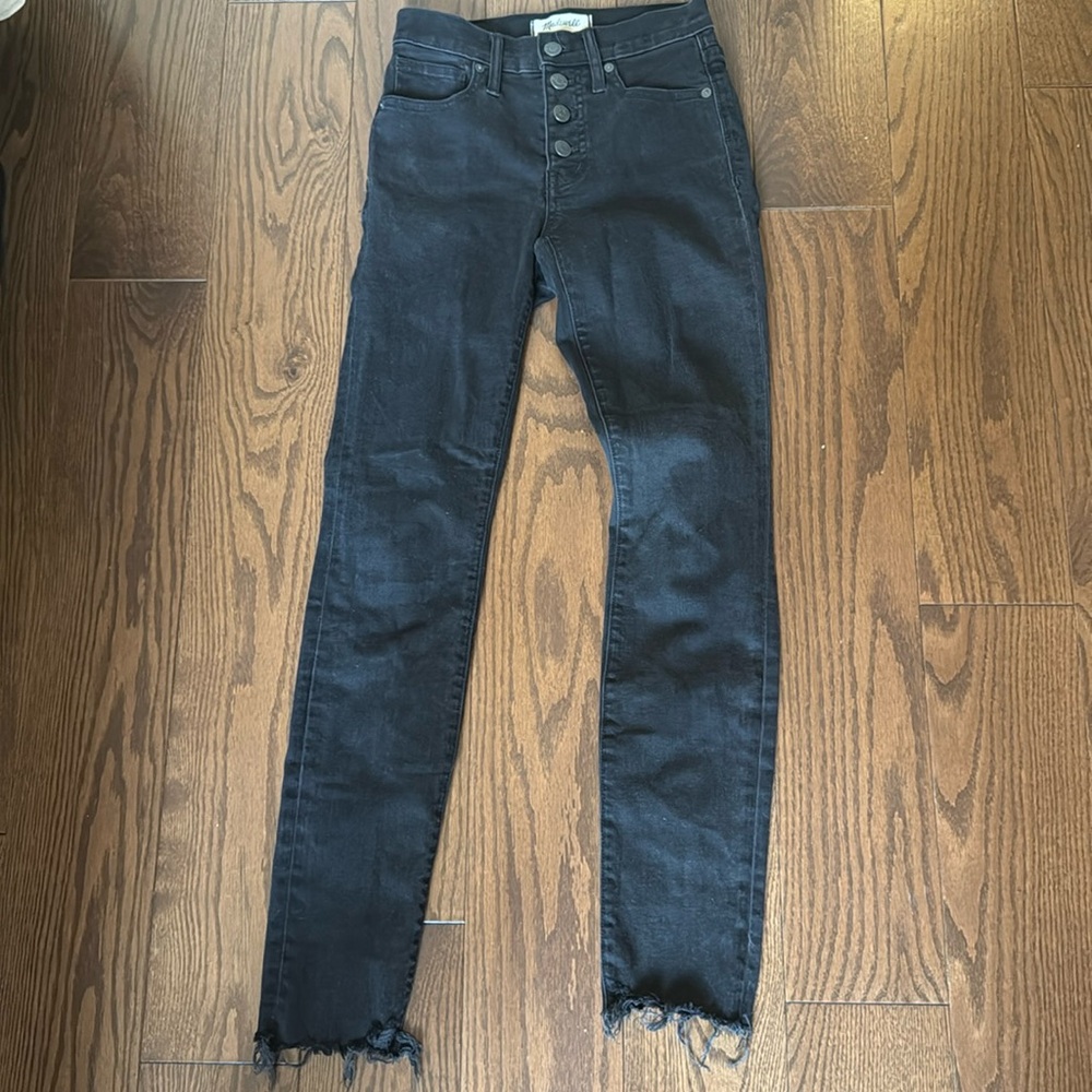 Madewell black jeans with frayed end and button closure